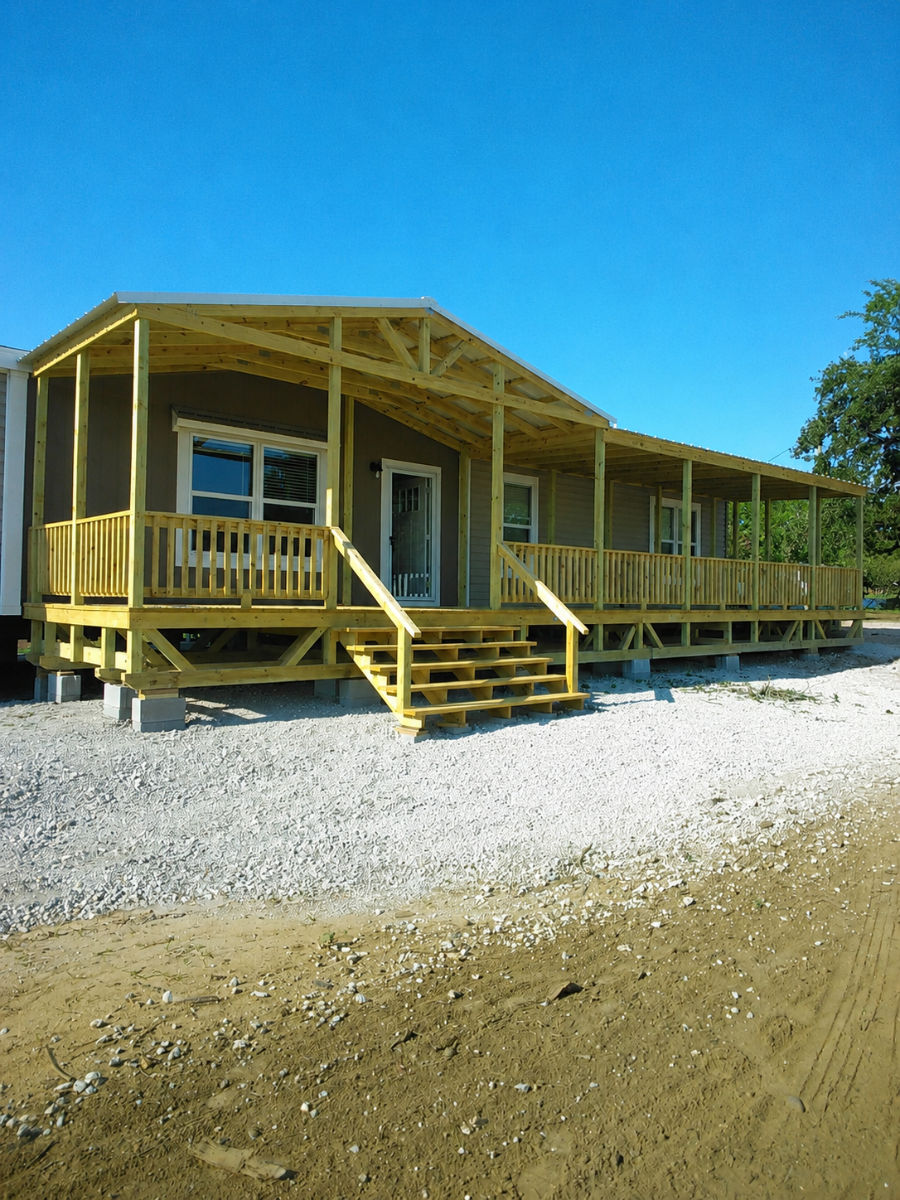 Covered portable wood deck with gable roof and wide stairs