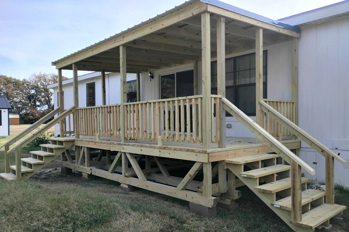 Covered wood deck with metal roof and two staircases