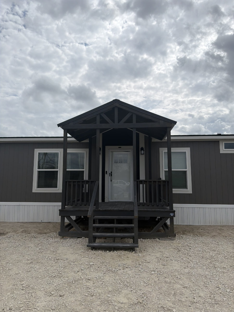 Dark charcoal covered portable deck with gabled timber roof