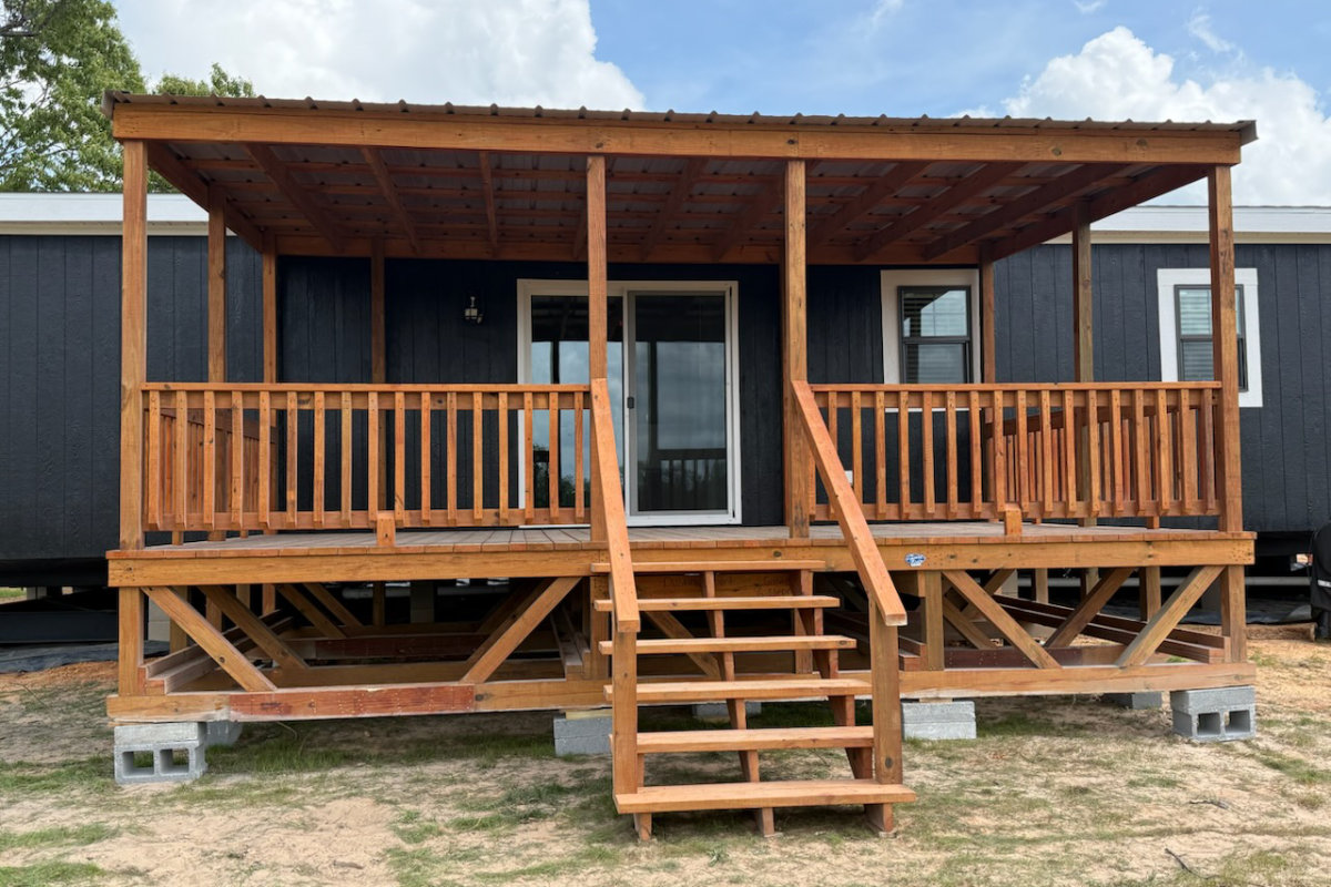 Covered light wood portable deck with central stairs
