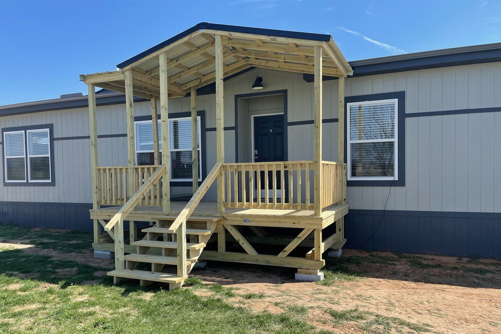 Covered portable deck with gabled roof and stairs