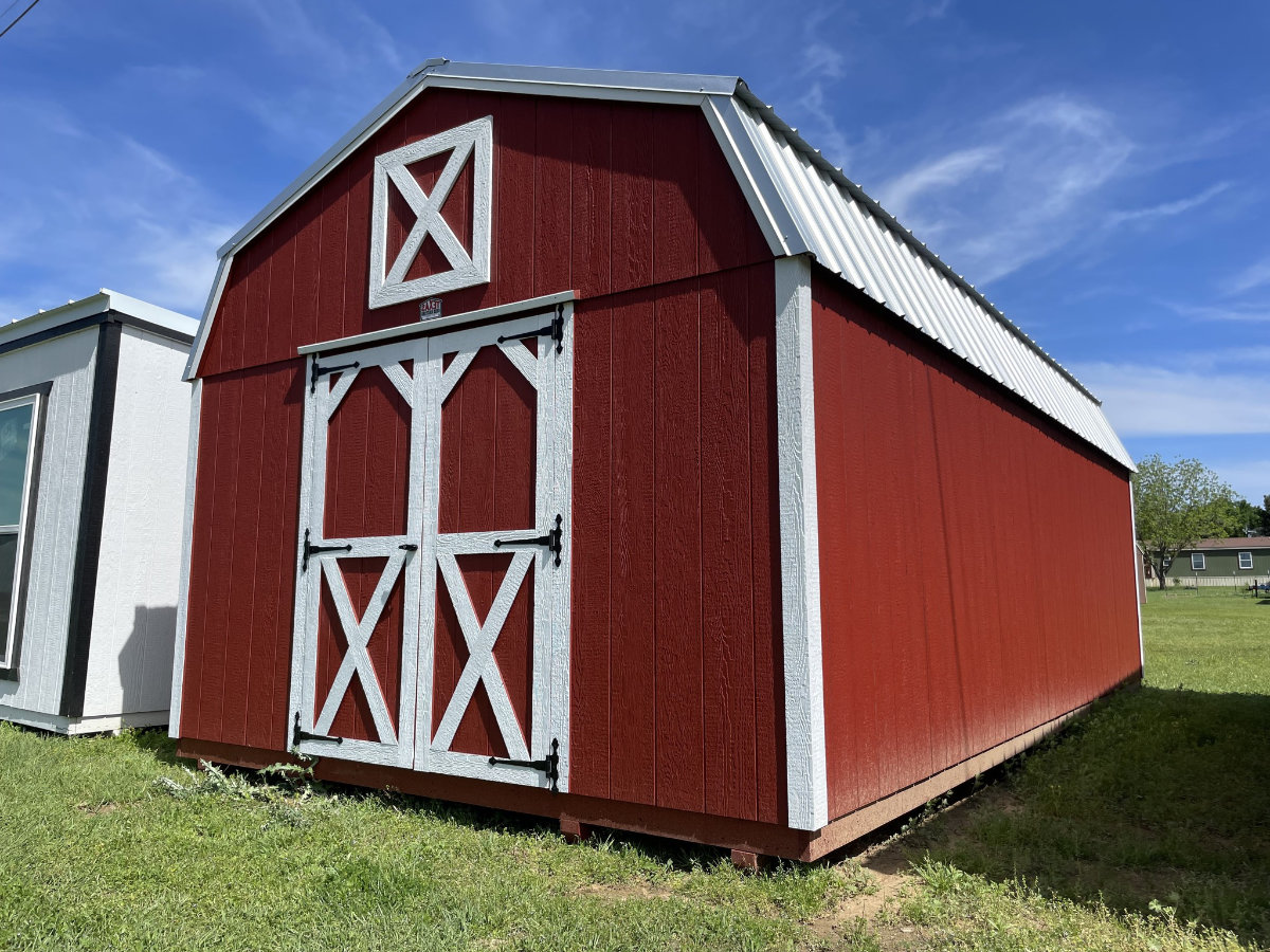 Red barn-style storage shed with white trim and double doors