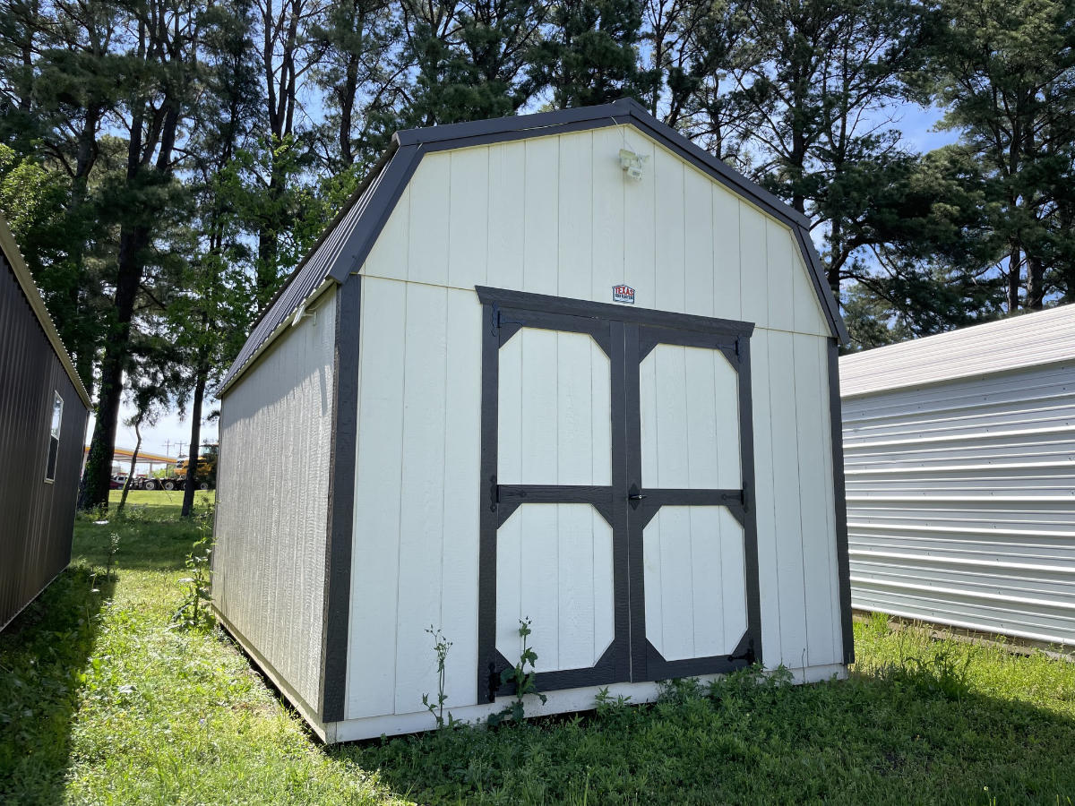 White lofted barn storage shed with gray trim and double doors